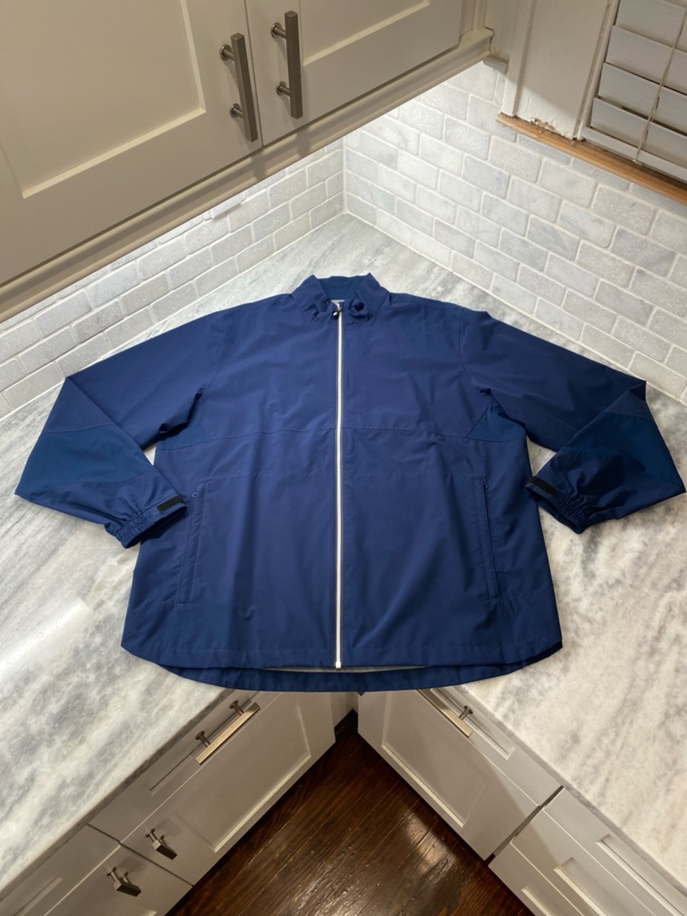 Men’s FootJoy HydroliteX full zip long sleeve rain jacket.